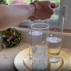 She drops sparkles in a glass of water for this breathtaking idea!