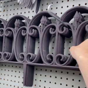 She hangs a Dollar Store fence from her ceiling…brilliant!