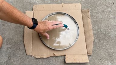 She lays a pot lid over cardboard for this brilliant backyard hack!