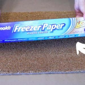 The genius reason she covers her doormat with freezer paper for Christmas!