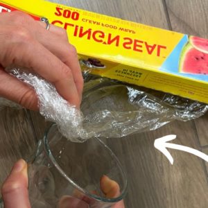 Stuff plastic wrap into glass for this BRILLIANT Christmas idea!