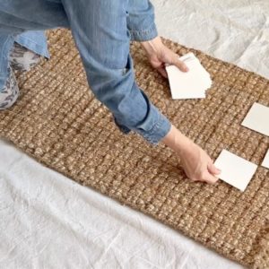 The genius reason she lays squares of paper on a rug