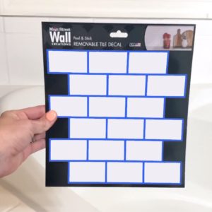 Everyone will be buying Dollar Store peel and stick tile when they see this bathroom idea!